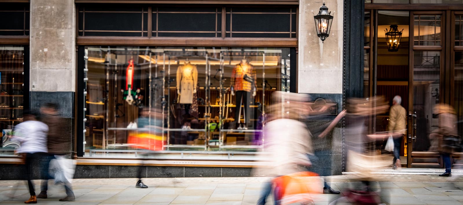 Image of people walking in front of a store