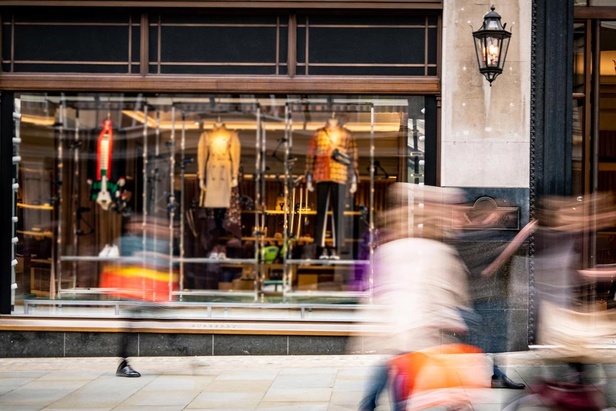 Image of people walking in front of a store