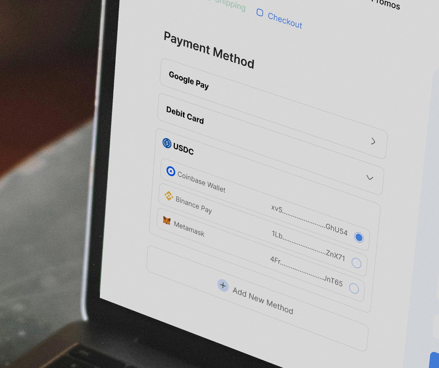 Laptop showing a payment screen with options to pay with USDC via a wallet