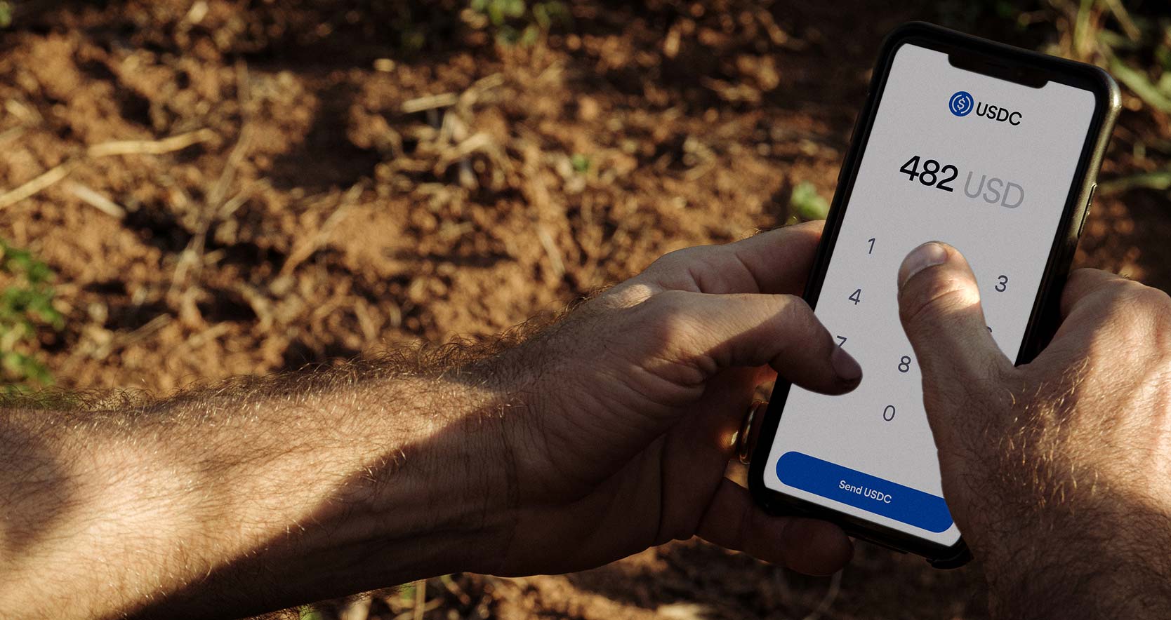 Photo of someone using an app to send USDC