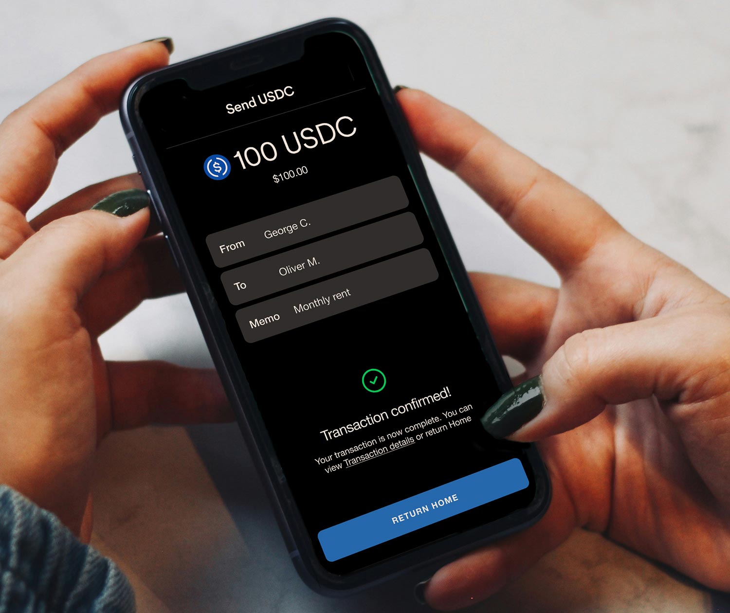 Image of a phone that has a screen with a completed transaction of sending USDC
